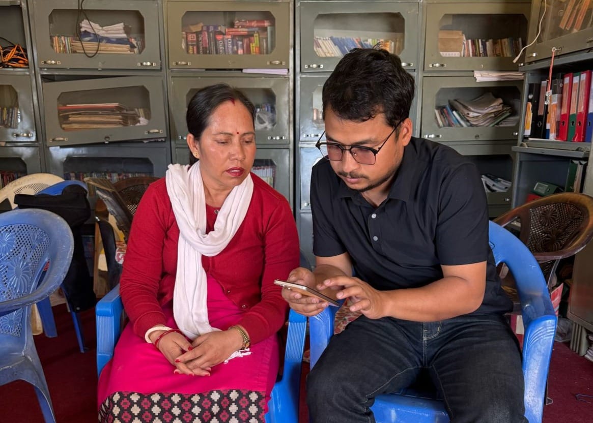 An enumerator asking survey questions from a local teacher in rural Karnali