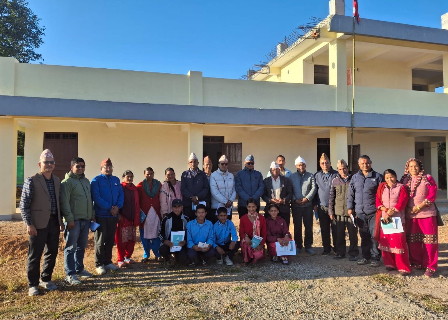 Teachers and guardians standing in front of Sarswatidevi Secondary School in Karnali