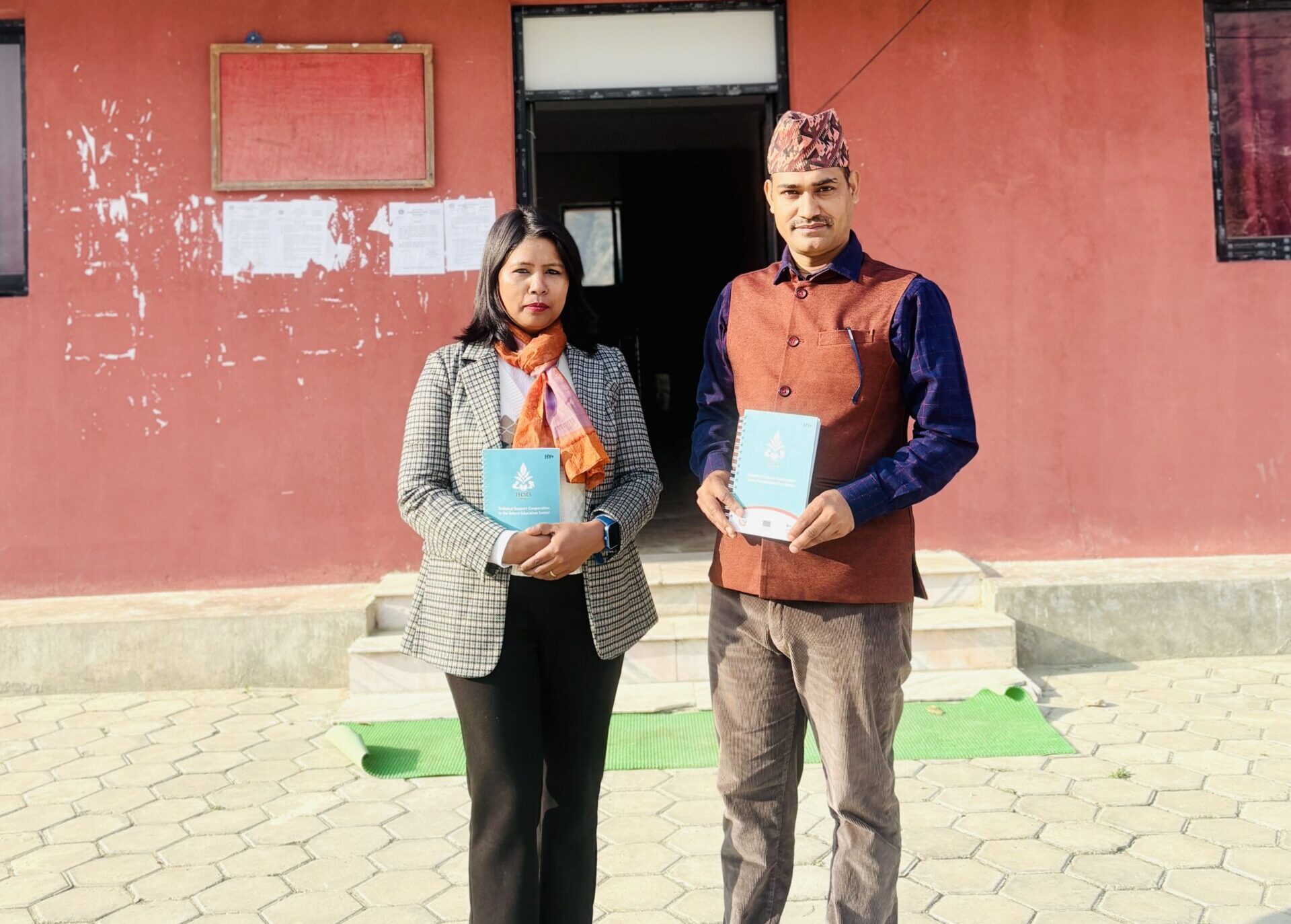 Tripti and Manoj standing in front of a local government building in Sudurspaschim