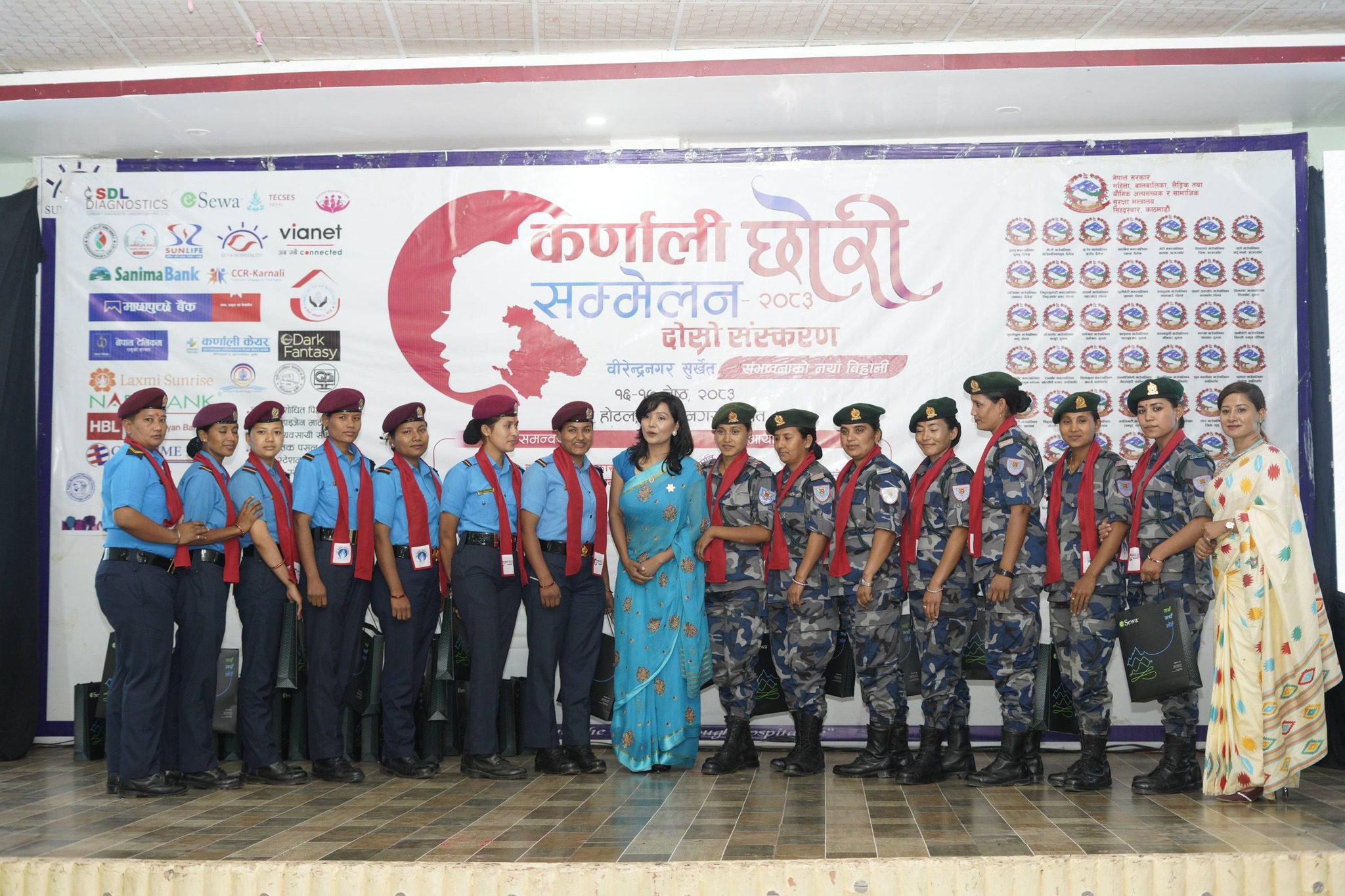 Female police officers standing in front of Daughter Conference banner