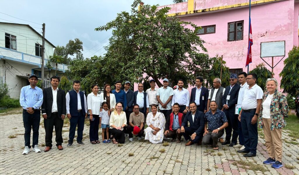 Participants and TECSES staff standing together on a courtyard.